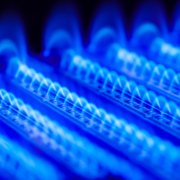 Propane flames burn inside of gas boiler furnace