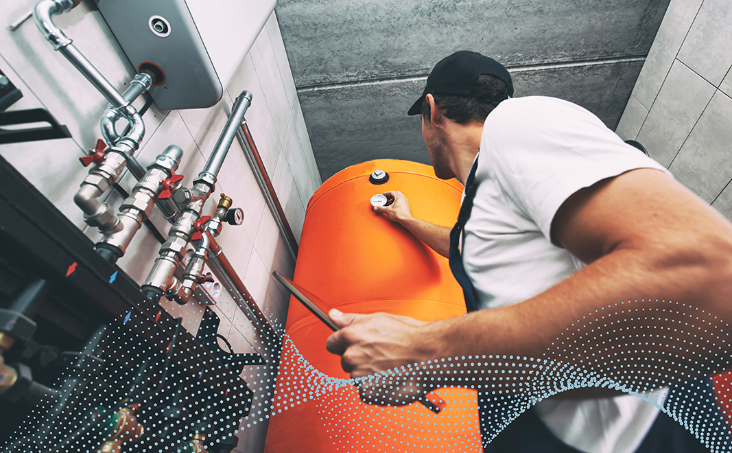 two chefs wearing kitchen whites prepare food surrounded by clean cookware