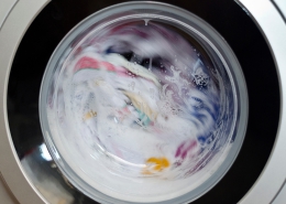 sudsy clothes mid-cycle in a front-loading washing machine