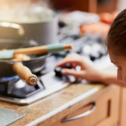 Cooking, kitchen and woman light gas stove in home for healthy diet, nutrition and meal preparation for eating food. Chef, pan and girl at cooker for lunch, dinner and turn on appliance in house