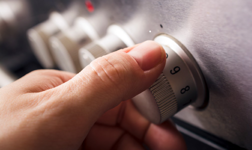 two fingers pinch and turn a gas stove range dial
