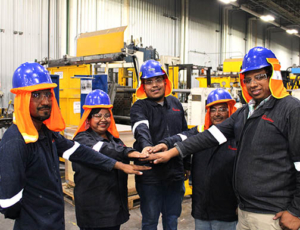 Team of construction workers touching hands