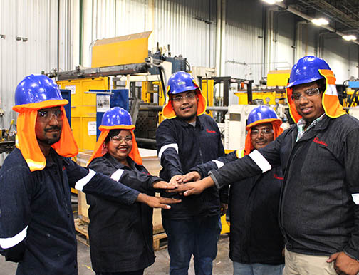 Team of construction workers touching hands