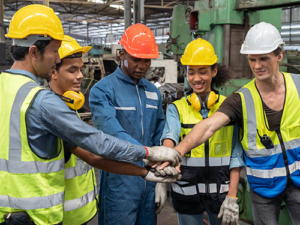 Team of construction workers joining hands